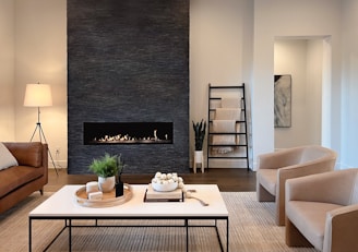 a living room filled with furniture and a fire place