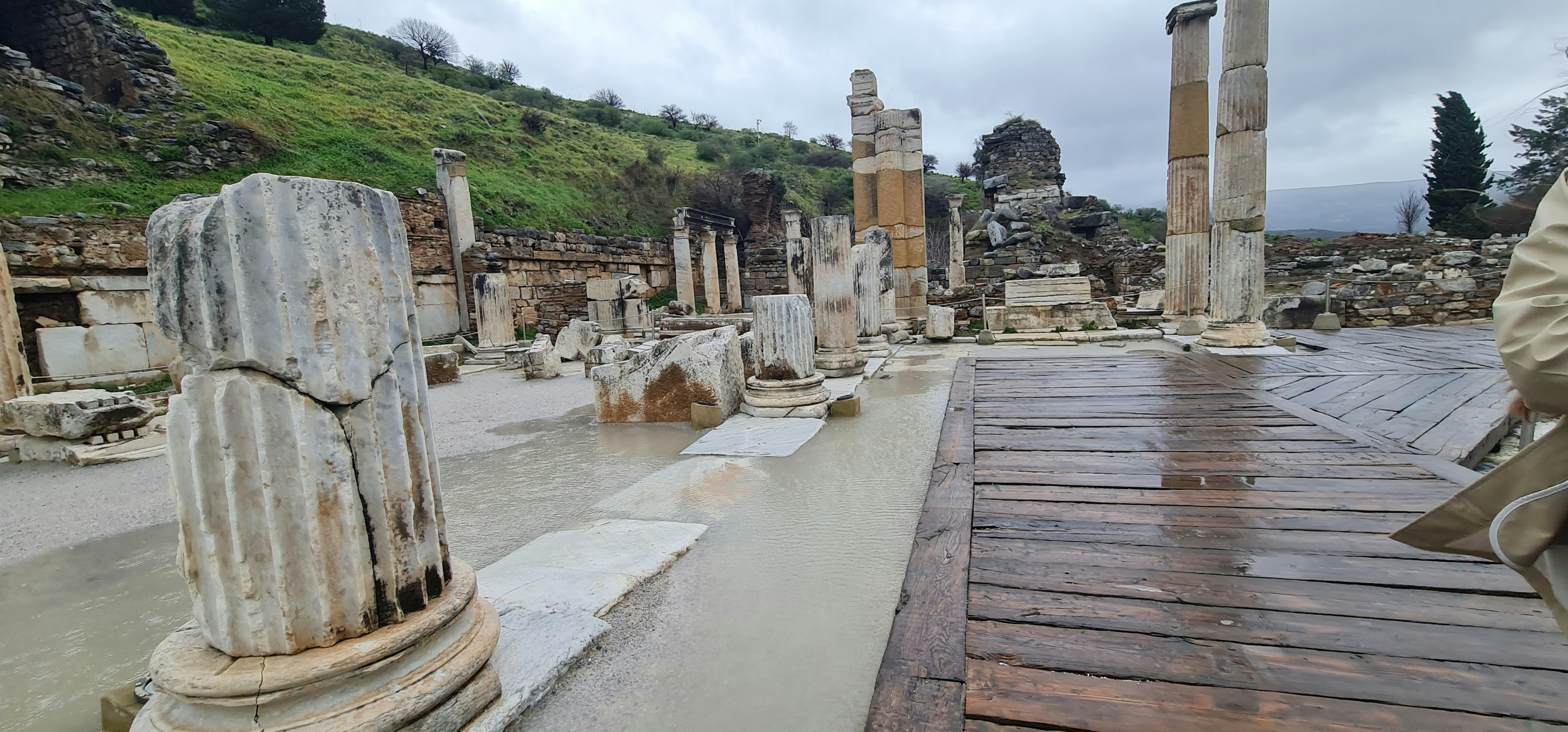 a man standing next to a wooden walkway, 