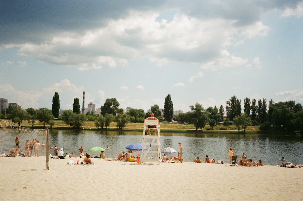 a lifeguard tower on a beach with people on it