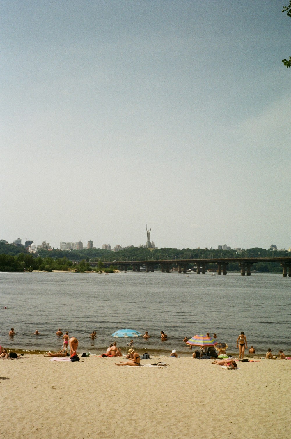 a group of people laying on top of a sandy beach