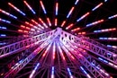 a ferris wheel lit up with red, white and blue lights
