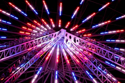a ferris wheel lit up with red, white and blue lights
