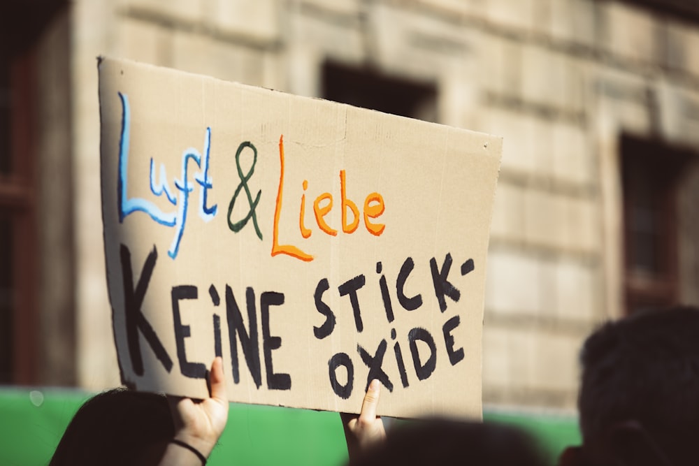 a person holding a sign that says life and libe