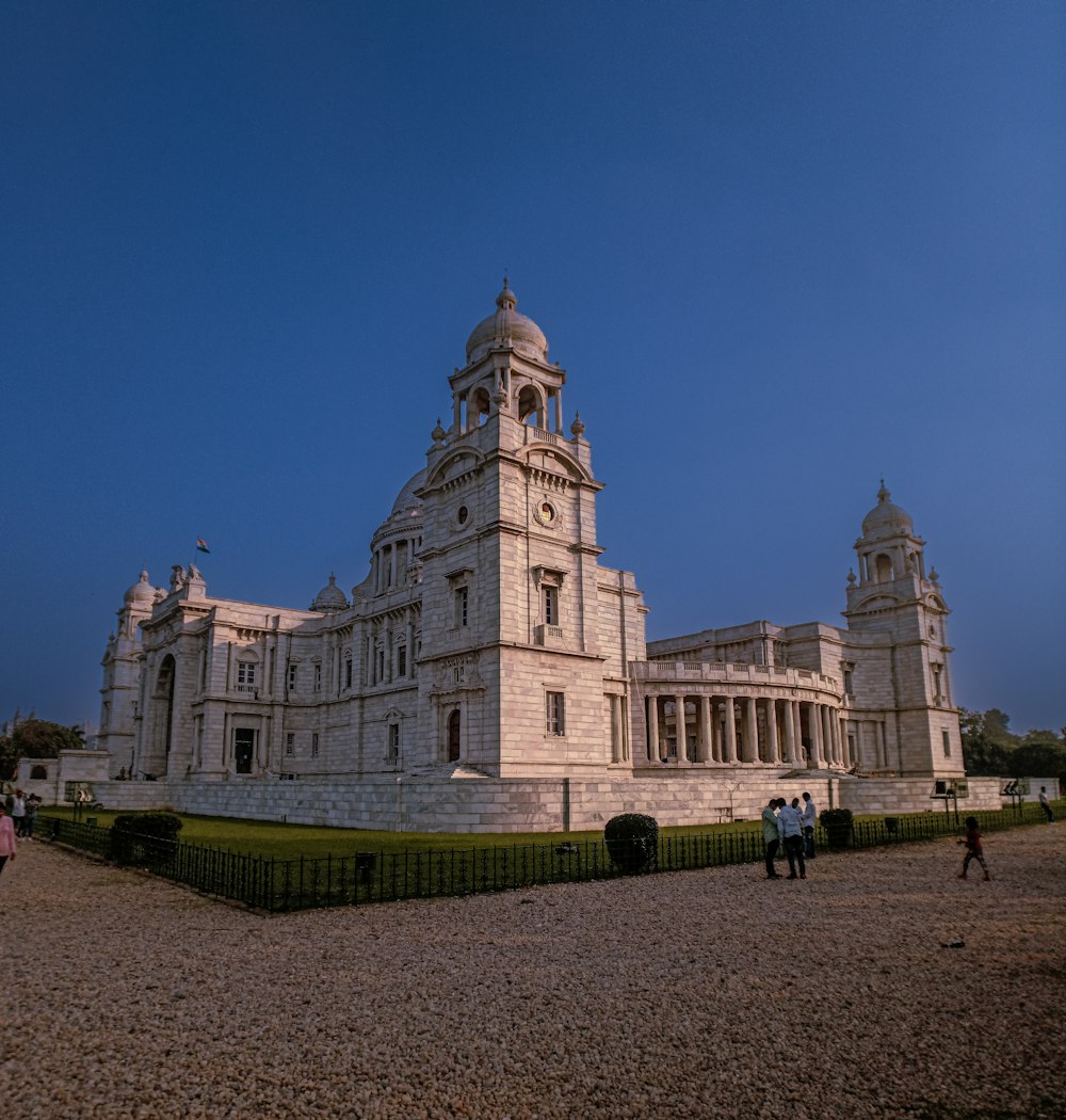 a large white building with a clock tower