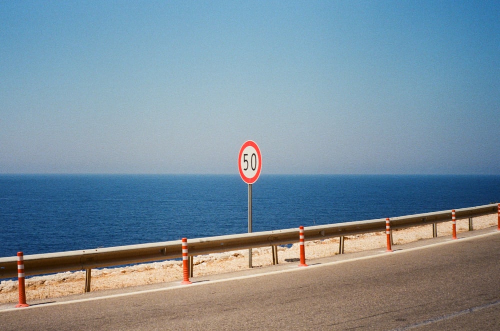 a speed limit sign sitting on the side of a road