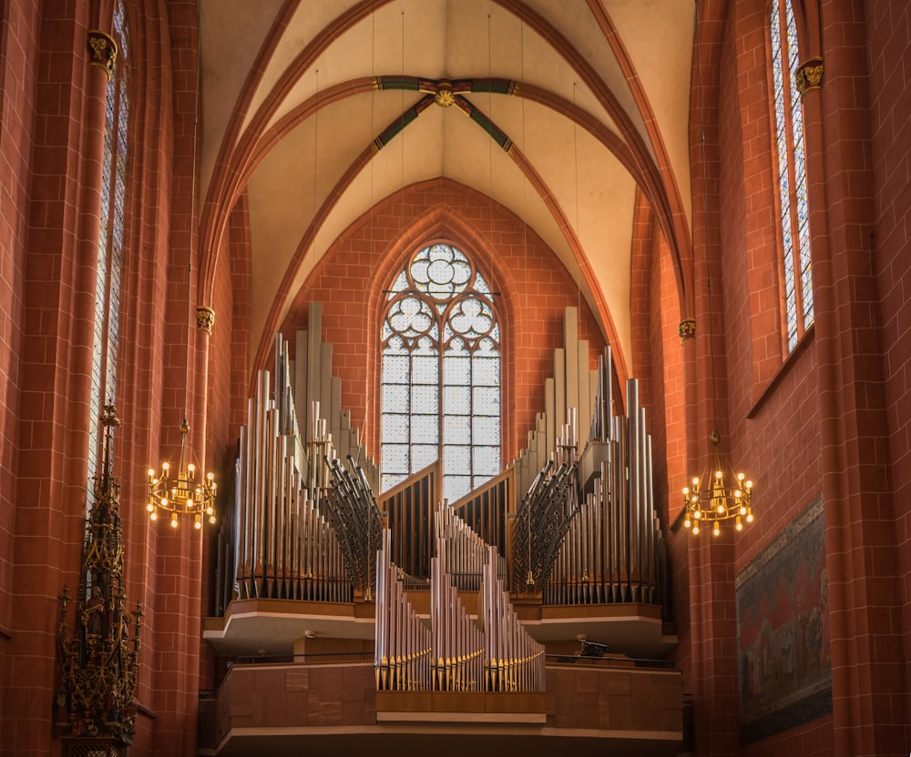 a church with a pipe organ and stained glass windows