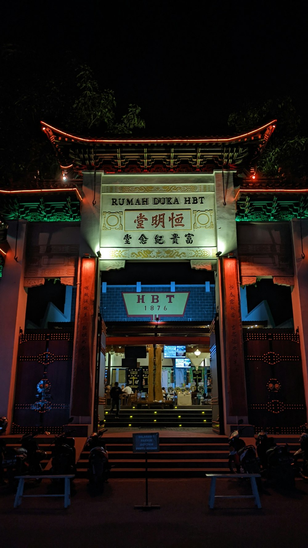 the entrance to a chinese restaurant lit up at night