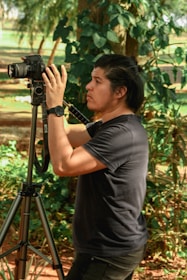 Friendly technician helping set up a photobooth at an outdoor wedding.