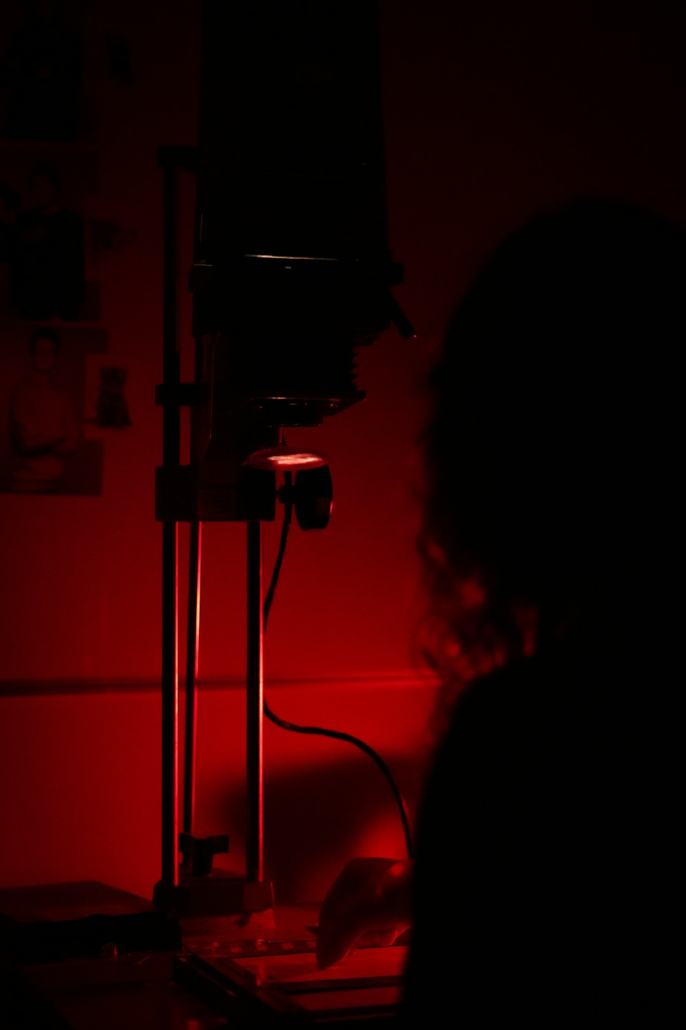 a woman sitting at a desk in a dark room