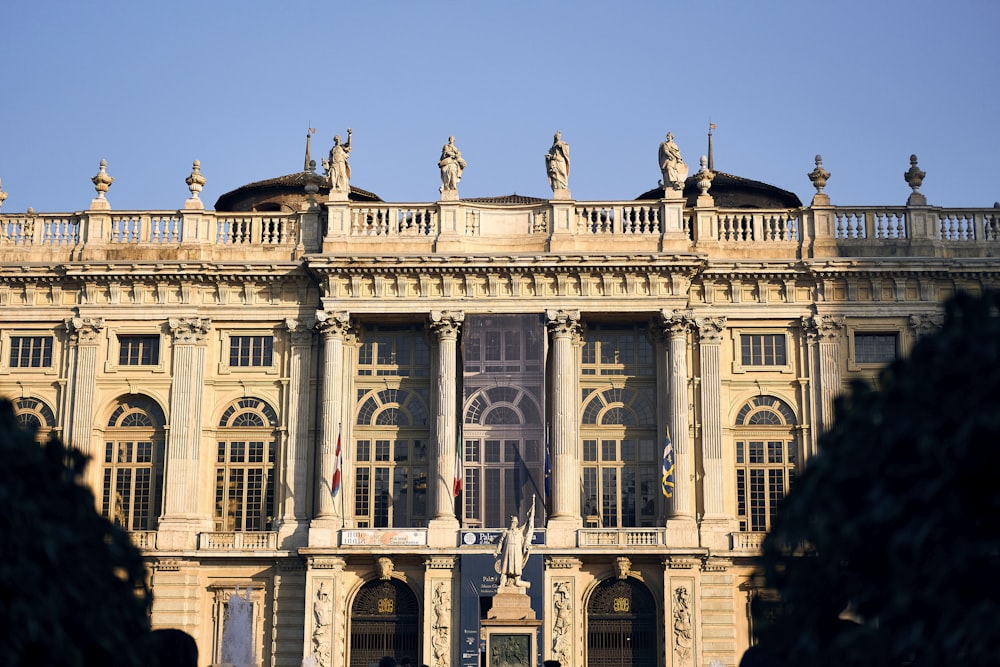 a large building with statues on top of it