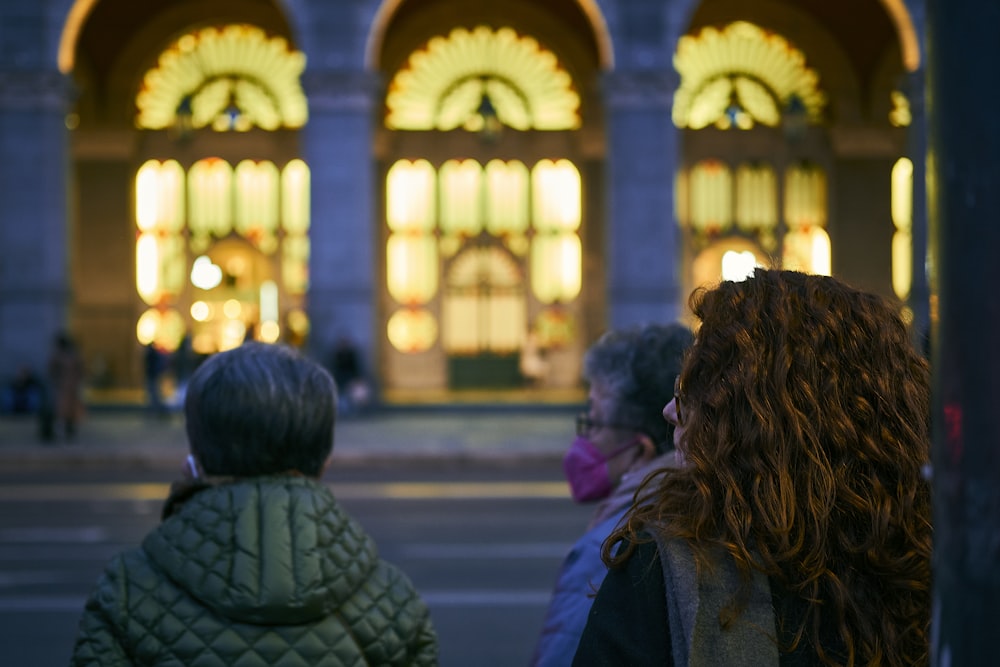 a group of people standing in front of a building