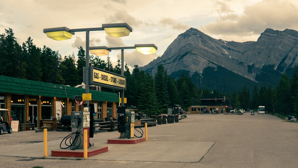 a gas station with mountains in the background