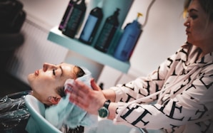 a man getting his hair washed in a salon