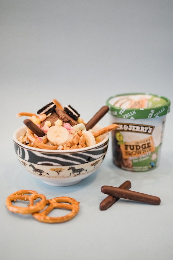 A bowl of cereal with pretzels and a cup of yogurt