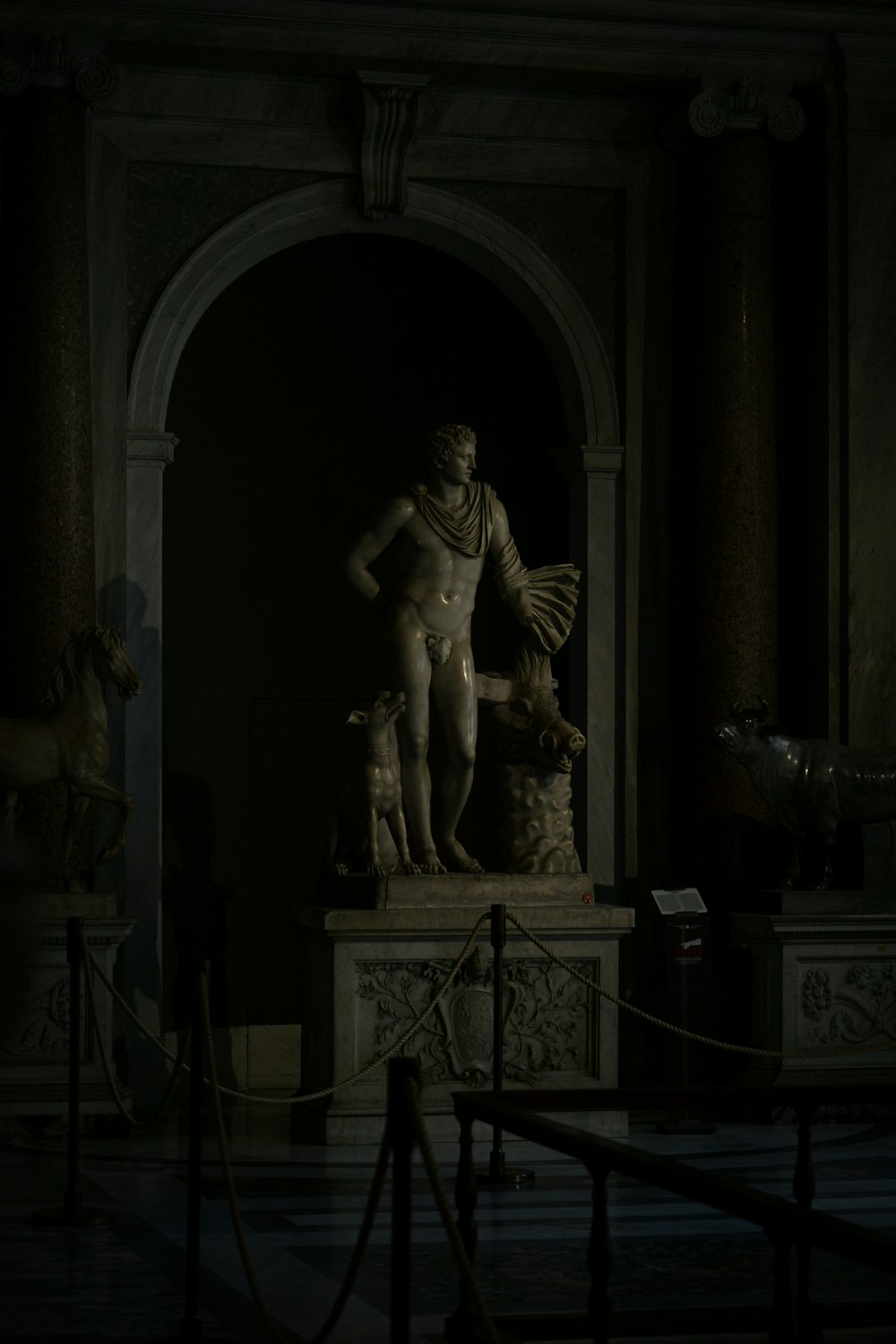 a statue of a man standing in a dark room