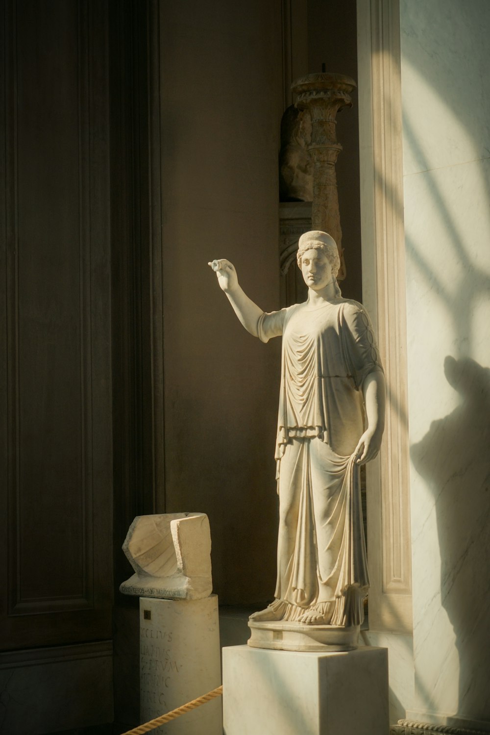 a statue of a woman holding a piece of paper