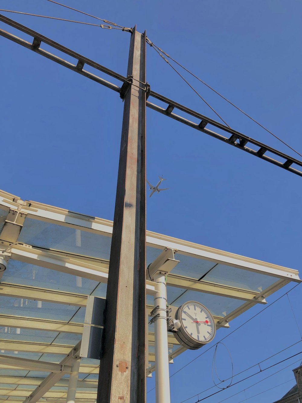 a clock on a pole next to a building