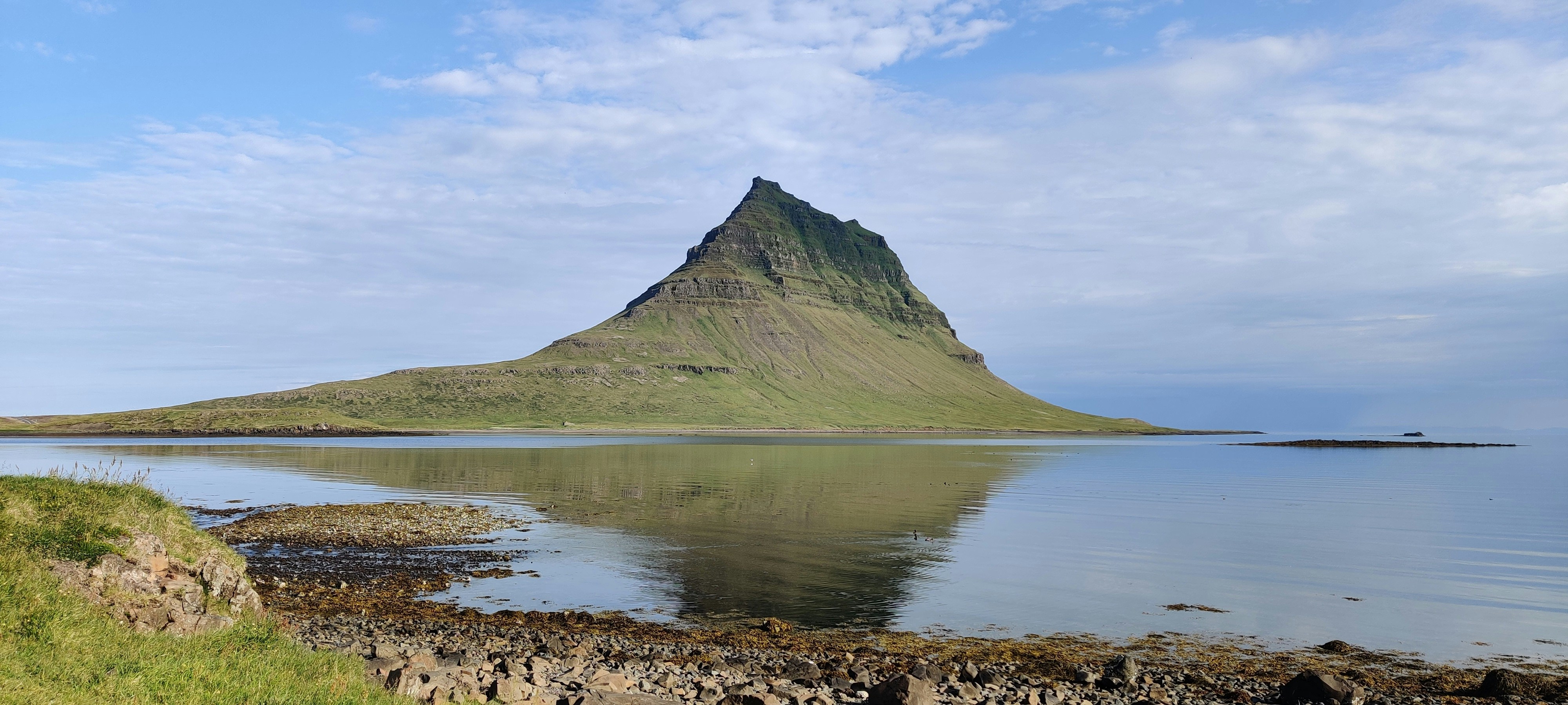 a large mountain sitting above a body of water