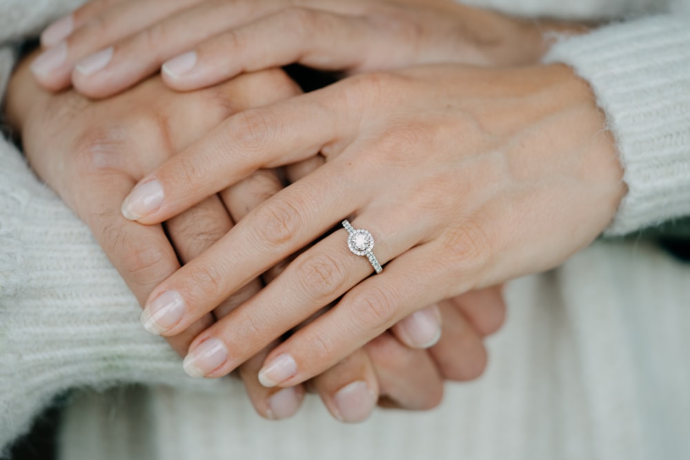 a close up of two people holding hands