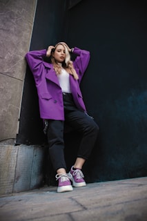 Model wearing a trendy purple mango jacket in an urban setting with soft purple and brown tones.