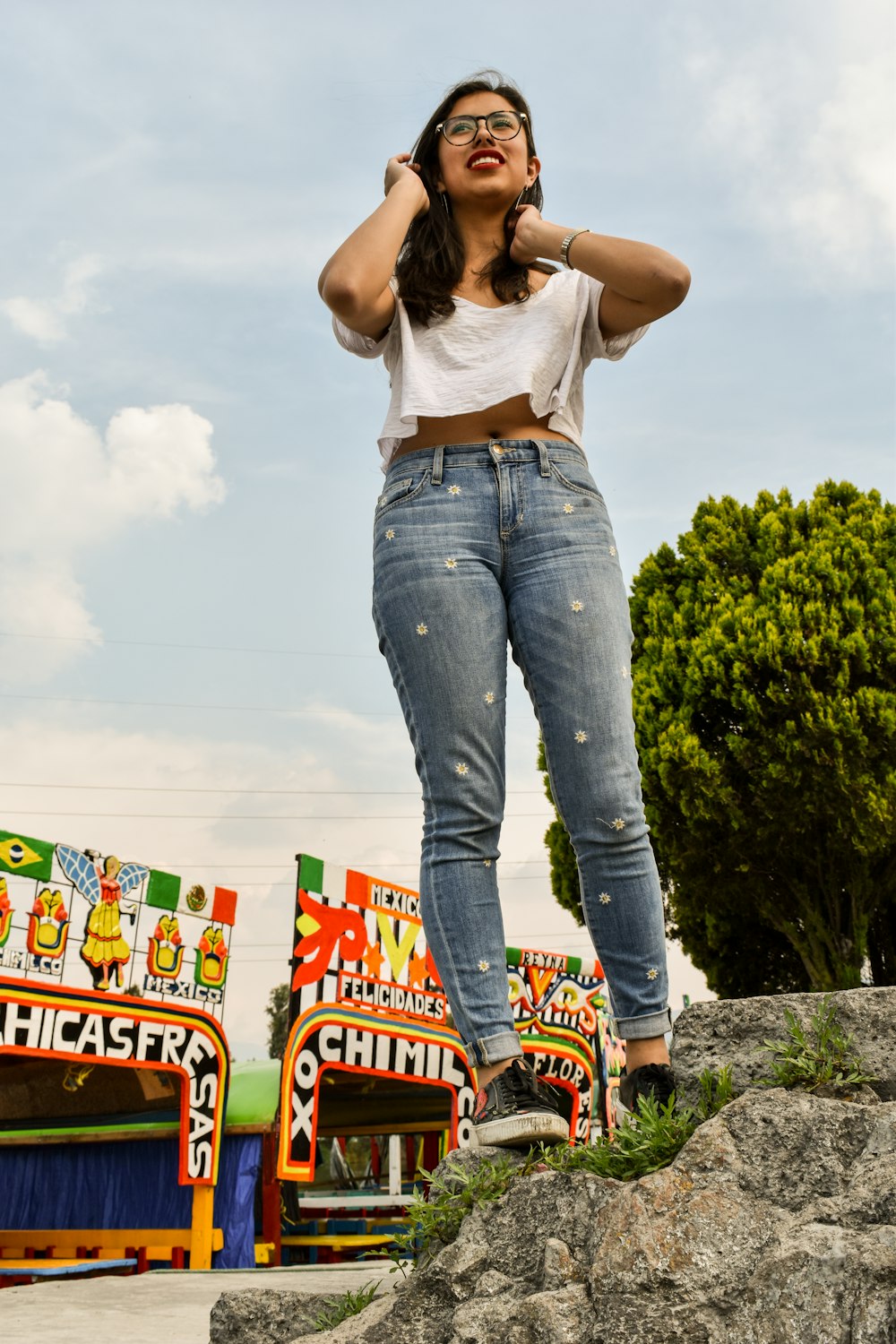 a woman standing on top of a pile of rocks