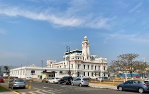 a large white building with a clock tower on top of it