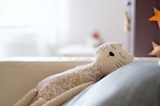 a stuffed animal laying on top of a couch