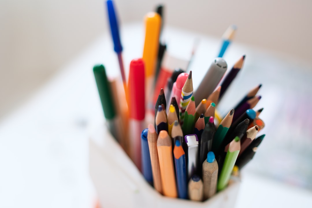 a cup filled with lots of different colored pencils