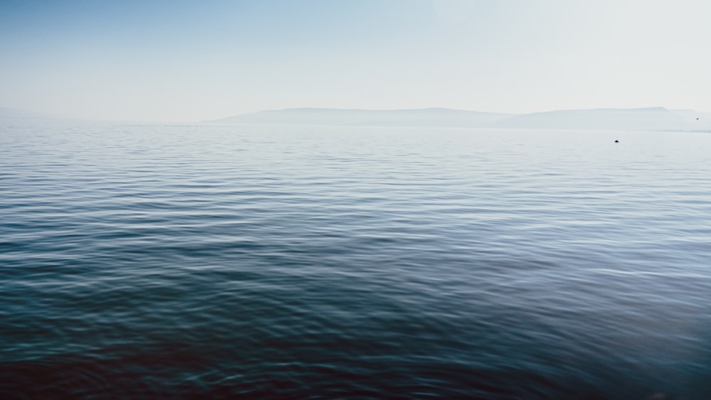 a body of water with a boat in the distance