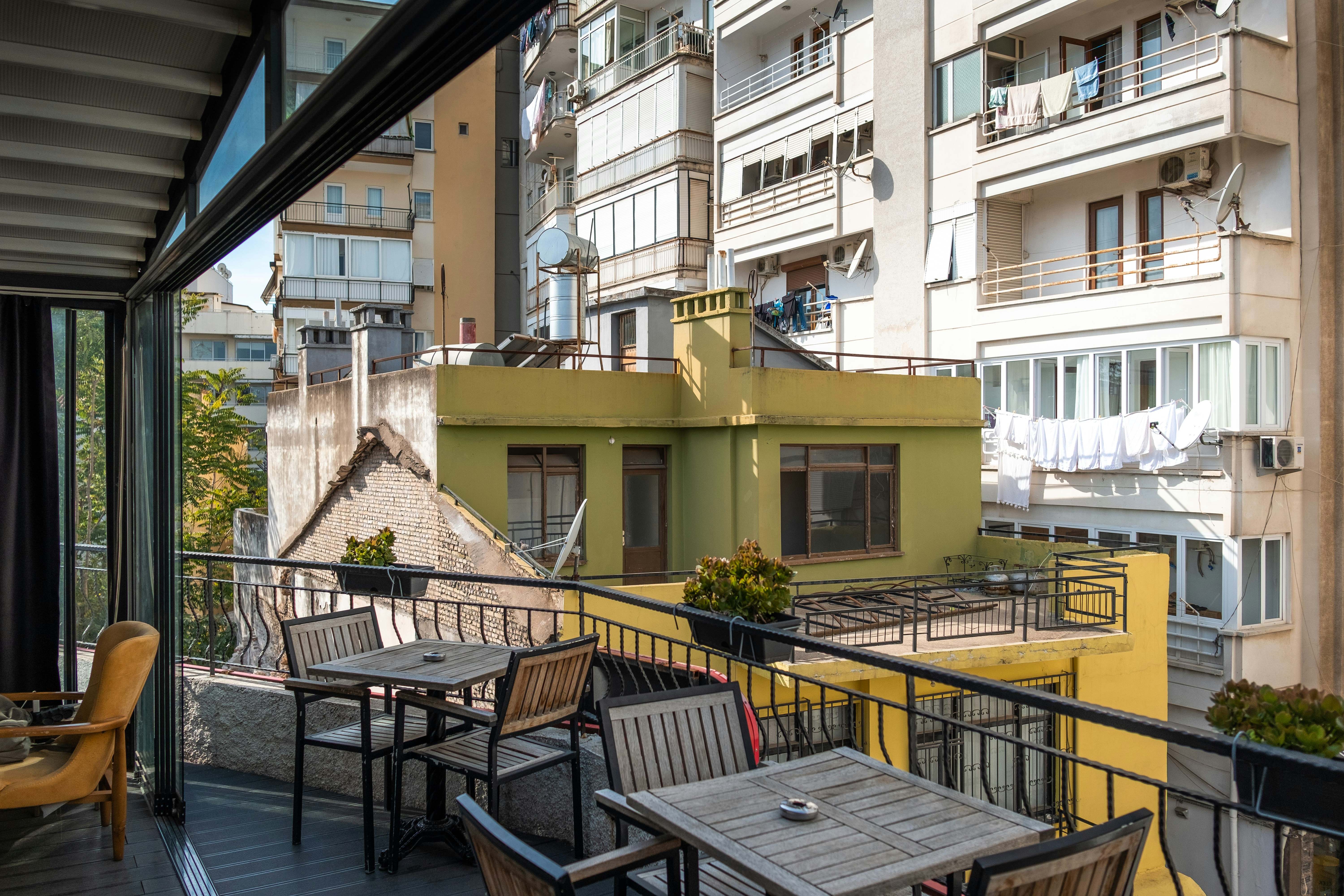 Balcony overlooking the cityscape, furnished with a small seating area for relaxing evenings.