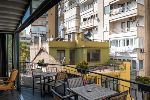 Close-up of a stylish apartment balcony overlooking a city park.