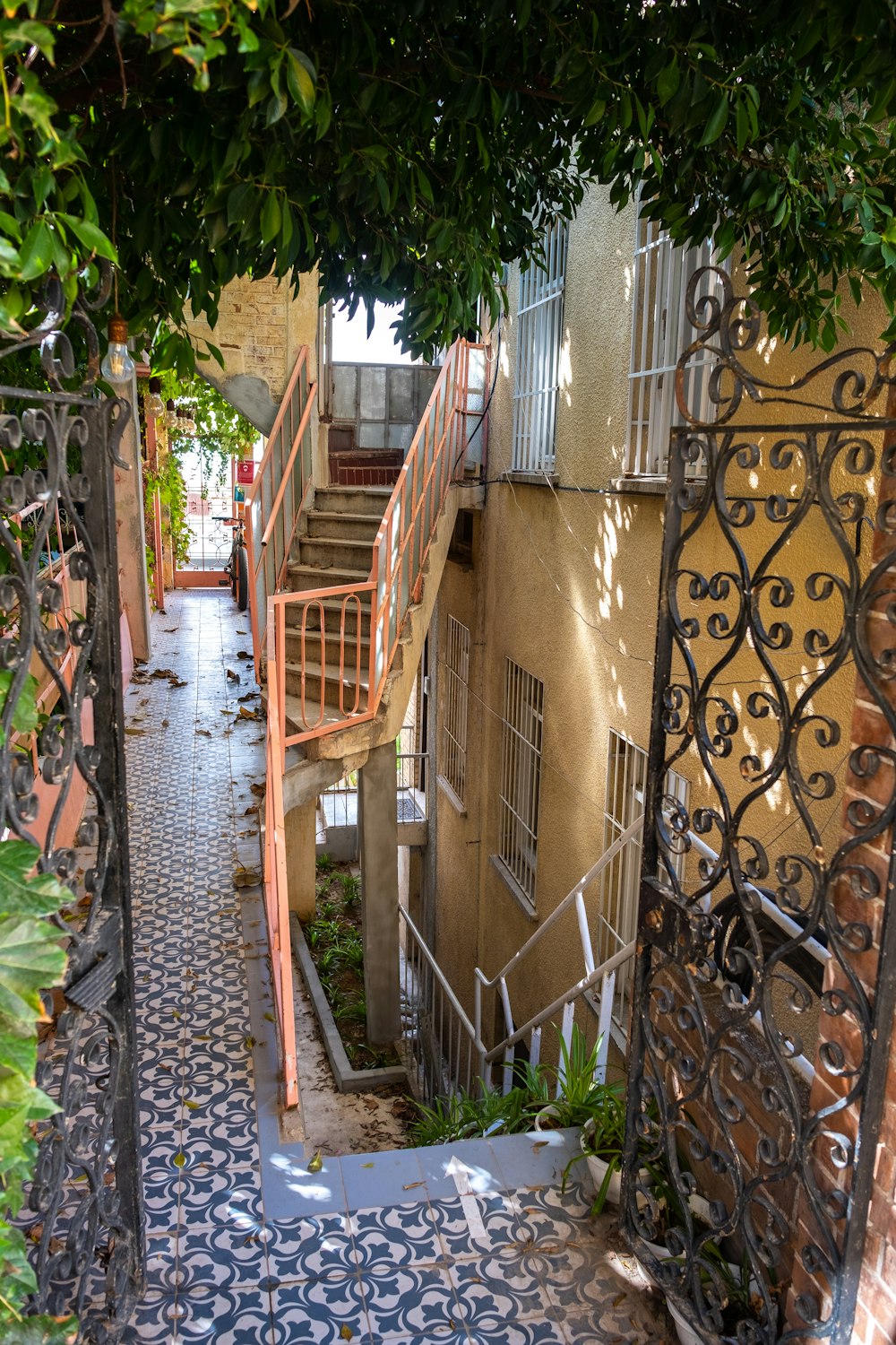 an alleyway with stairs and a tiled floor