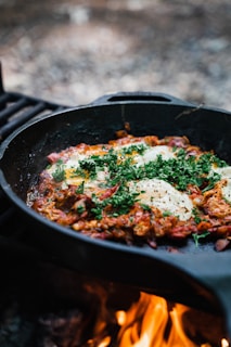 a skillet filled with eggs on top of a stove