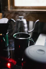A cozy kitchen scene with a Frostara Thermo King tumbler steaming beside a morning window.