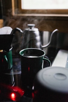 A cozy kitchen scene with a ceramic mug steaming beside a window, emphasizing the mug’s inviting texture.