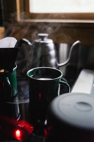A cozy kitchen scene featuring scald-proof ceramic mugs steaming with hot tea.