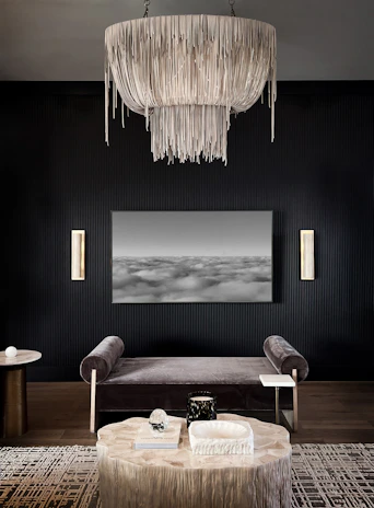 Luxurious modern living room with deep black walls, subtle golden accents, and spacious layout.