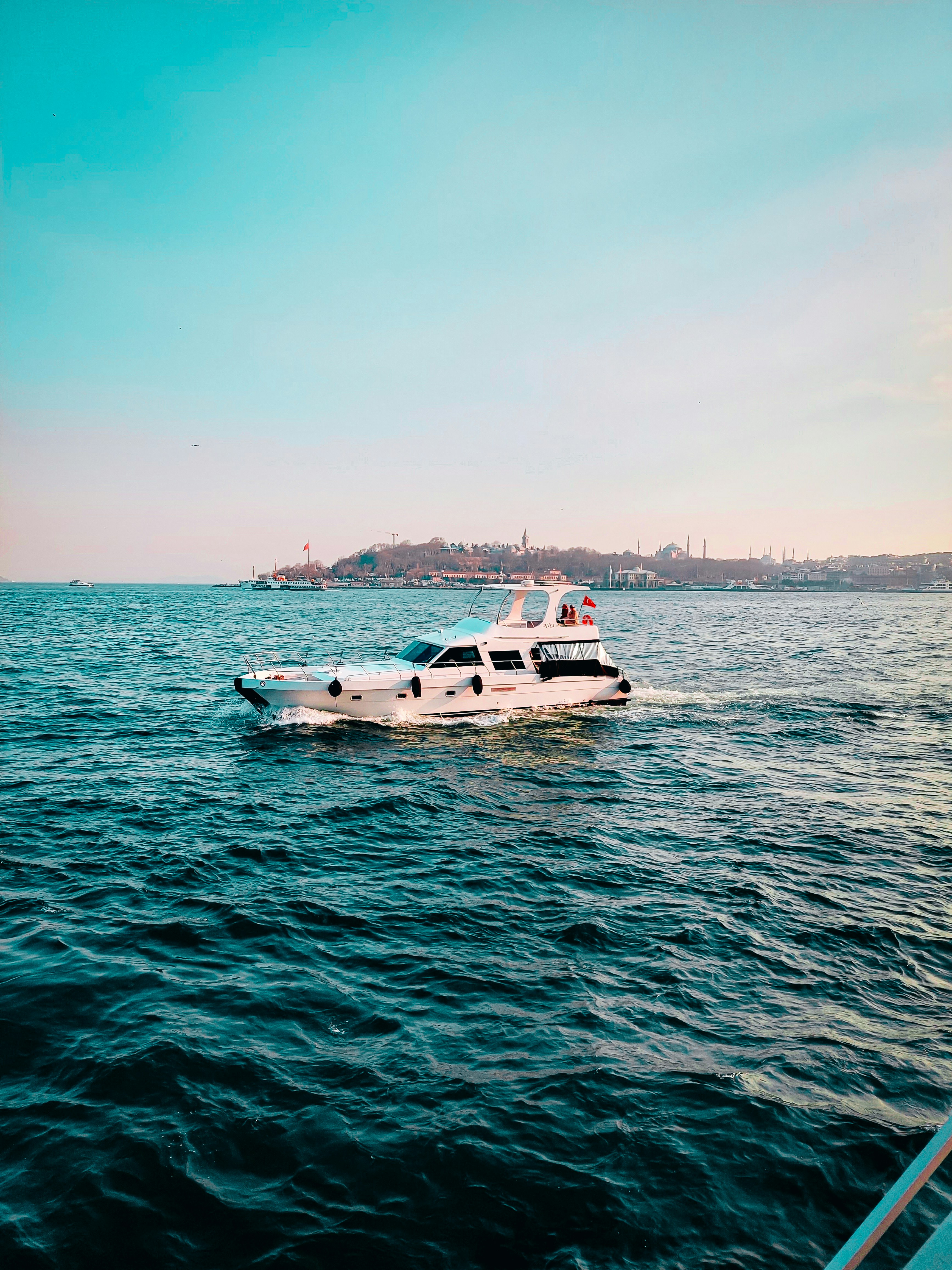 a white boat floating on top of a large body of water