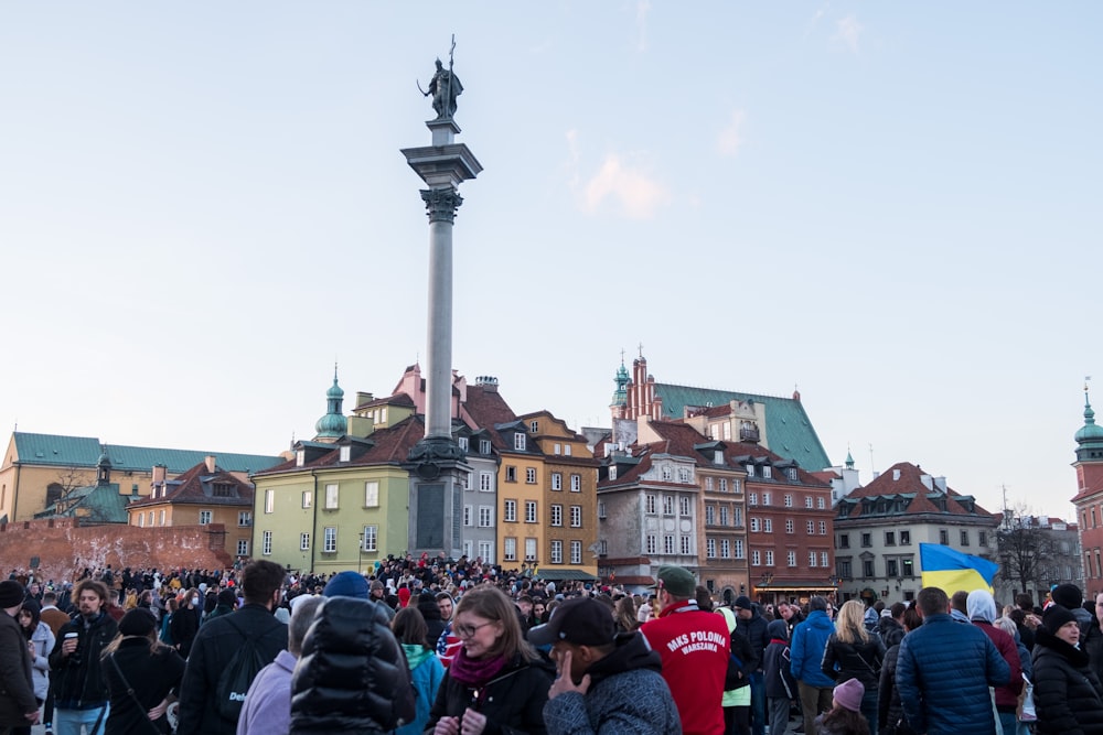 a crowd of people standing in front of tall buildings