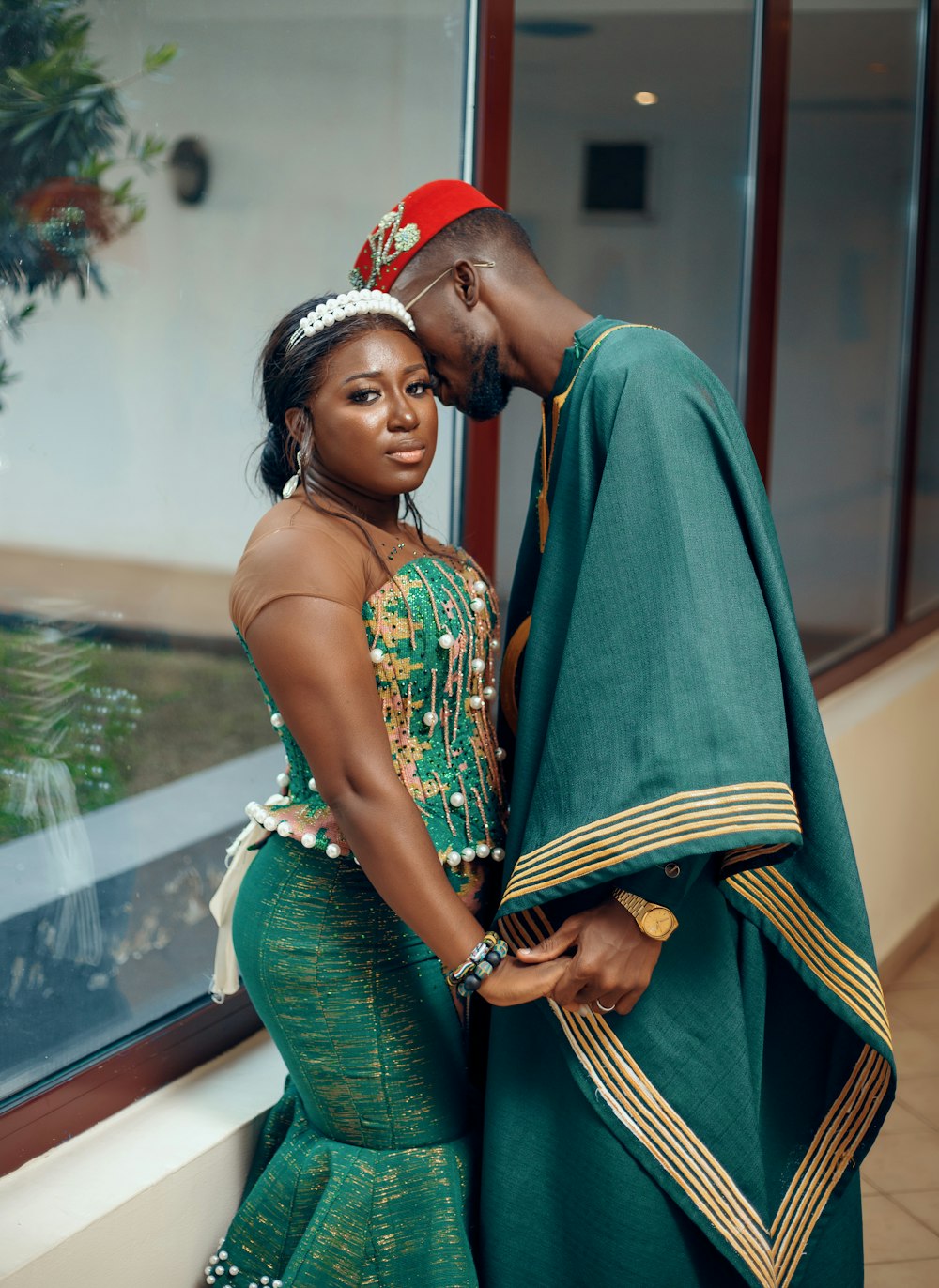 a man and woman dressed in traditional african clothing