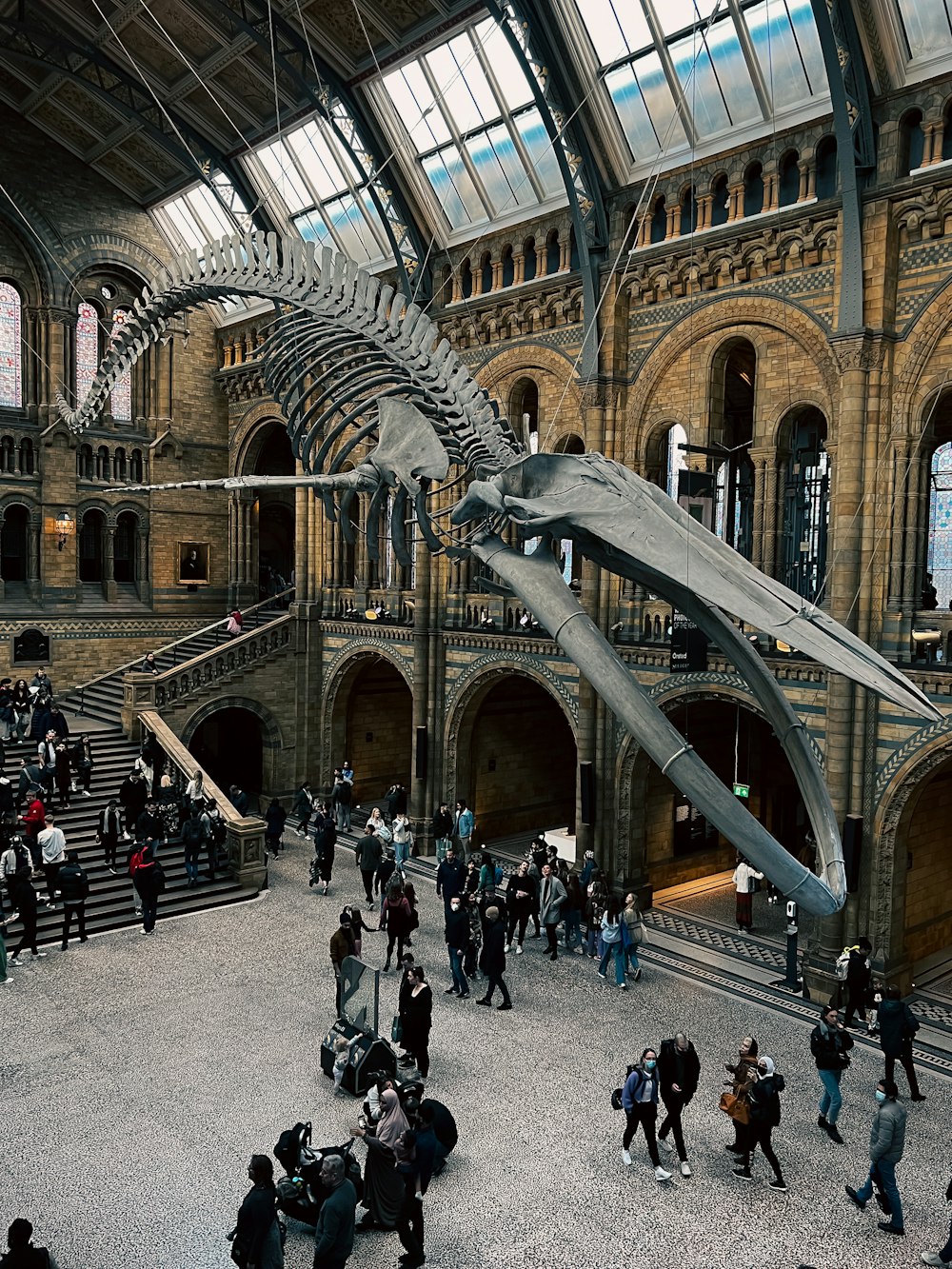 a group of people walking around a museum