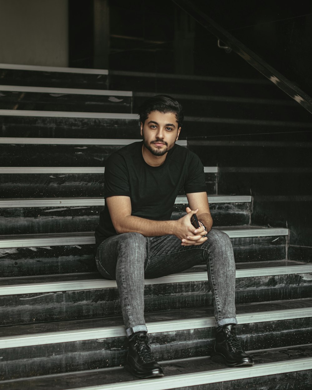 a man sitting on a set of stairs