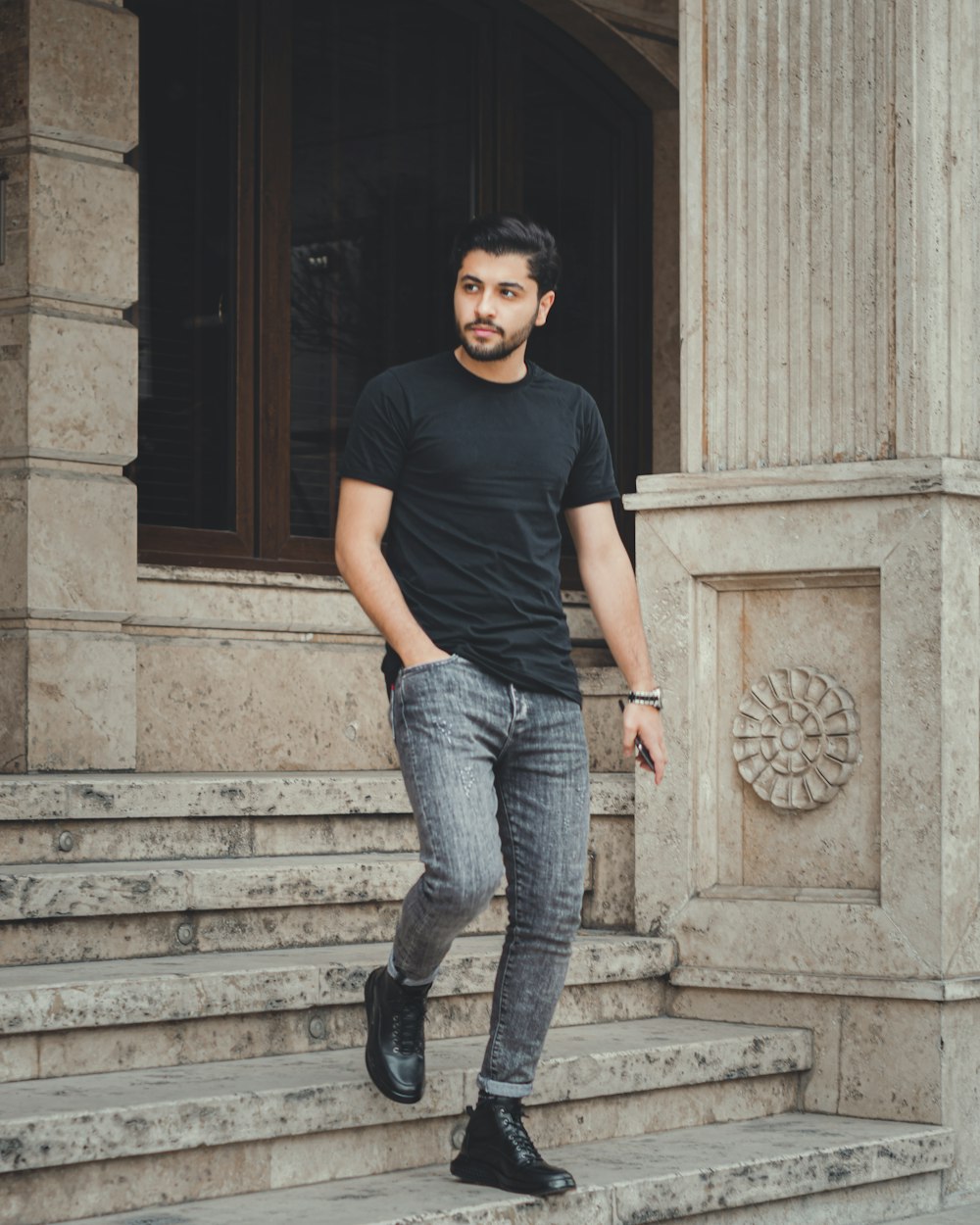 A man in black shirt and jeans standing on steps photo – Free Grey Image on  Unsplash