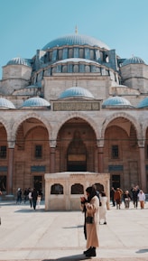 a couple of people standing in front of a building