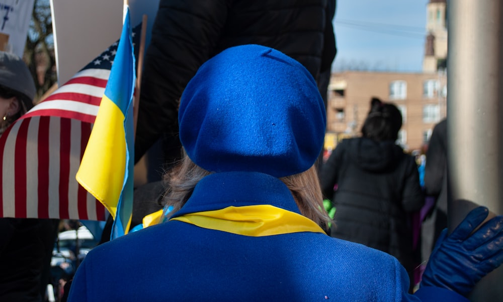 a person in a blue coat and a flag