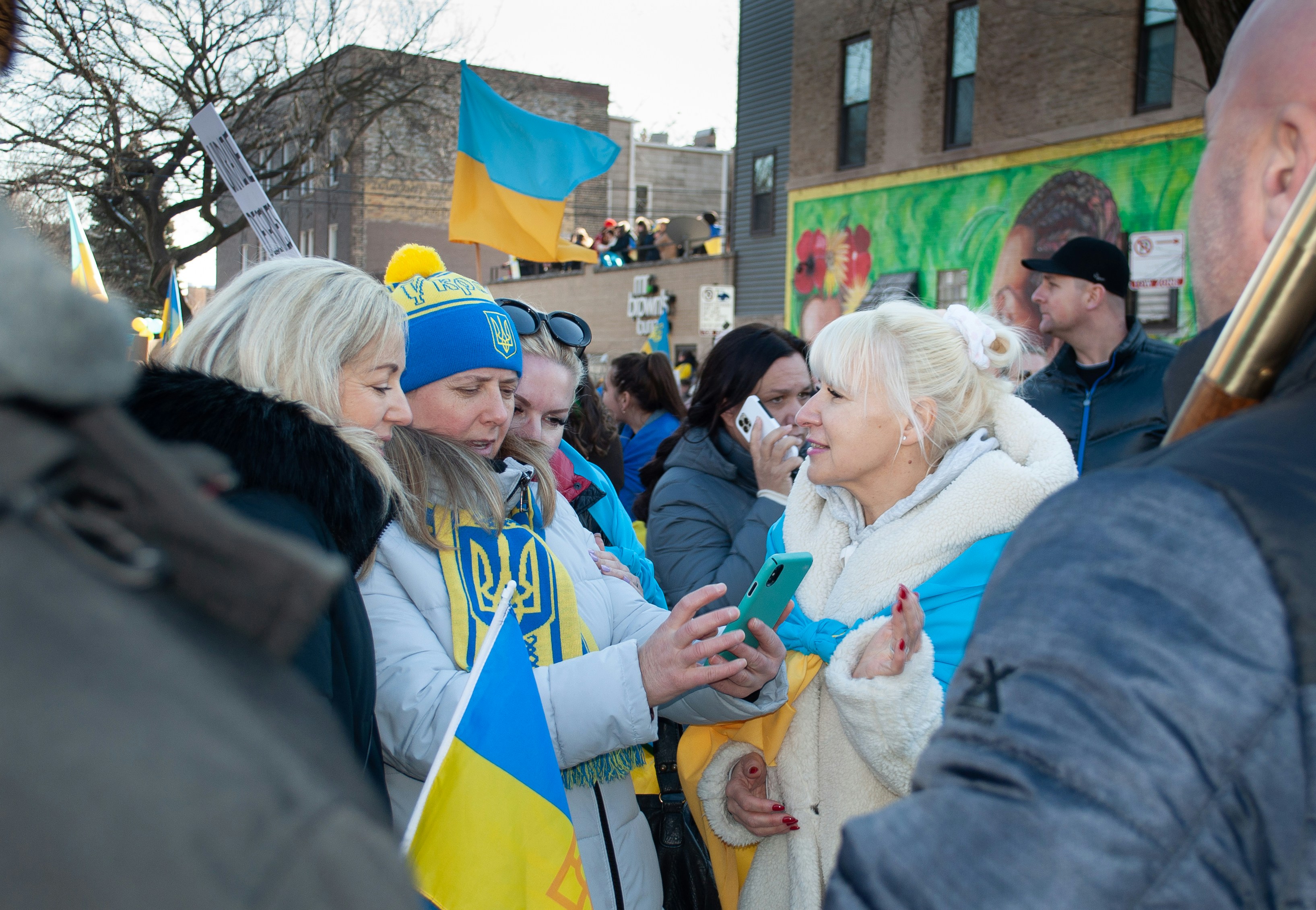 a group of people standing around each other