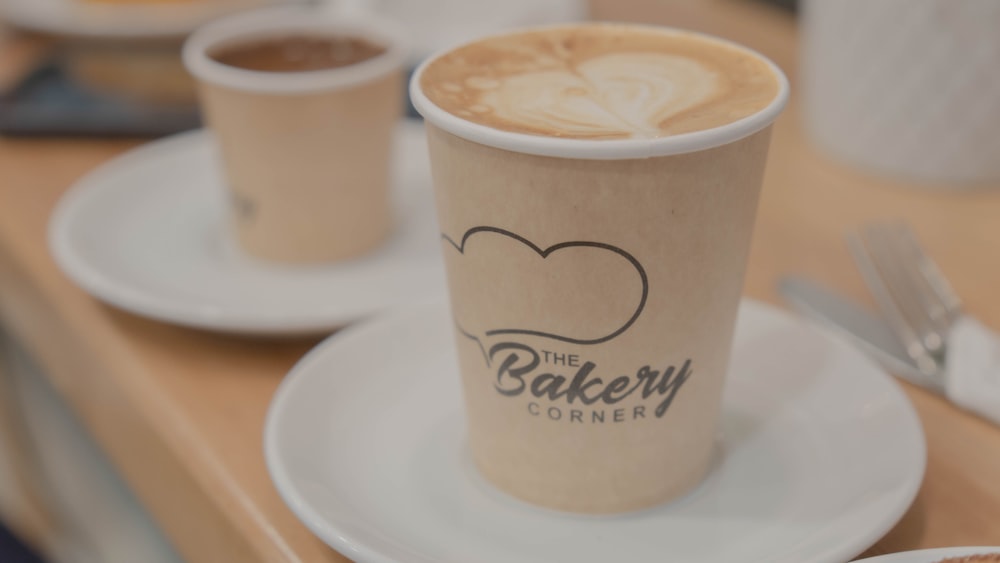 a couple of cups of coffee sitting on top of a white plate