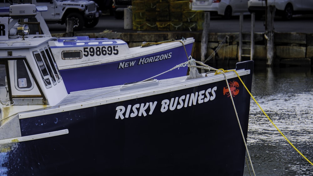 a blue and white boat tied to a dock