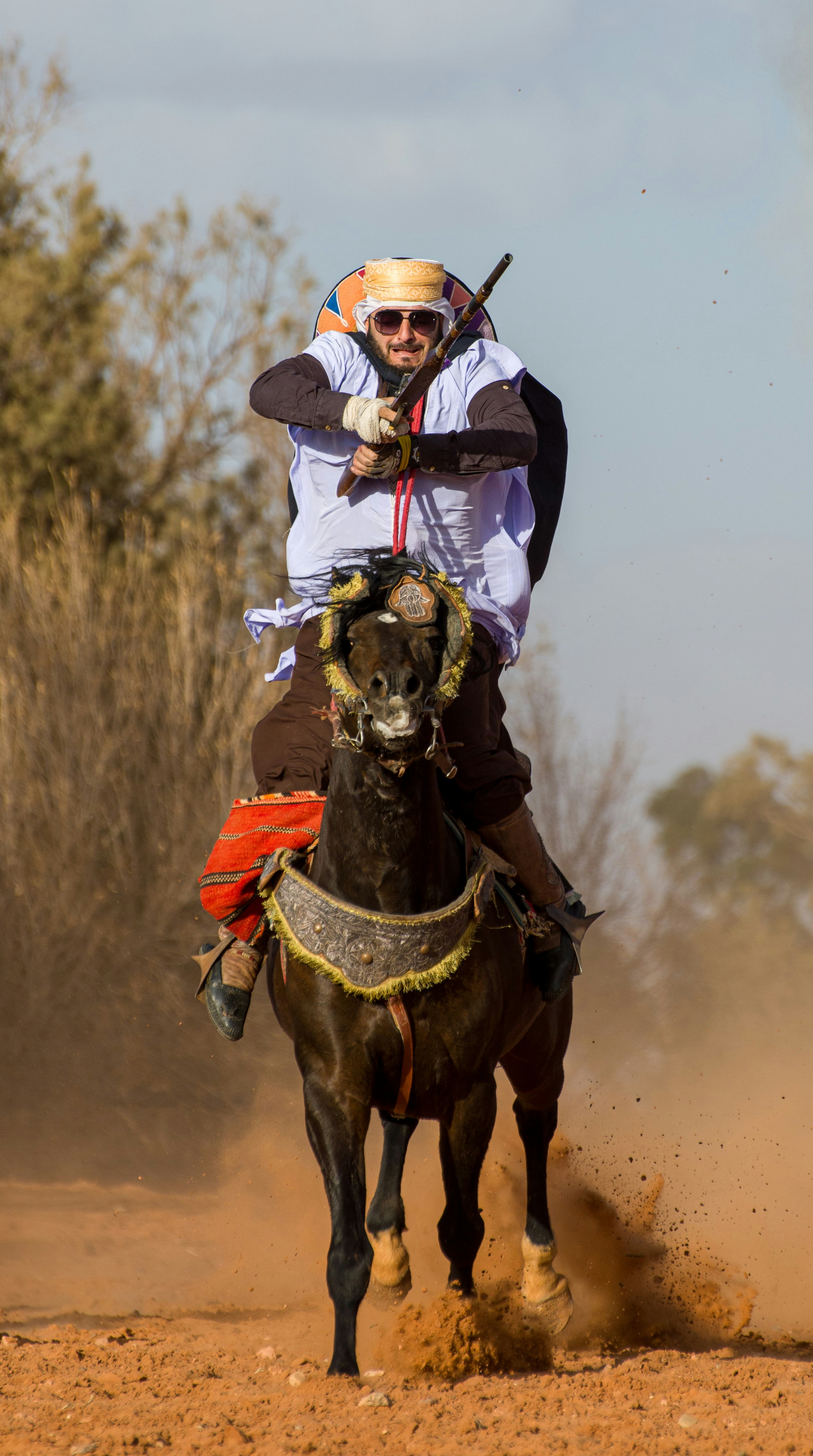 a man riding on the back of a brown horse