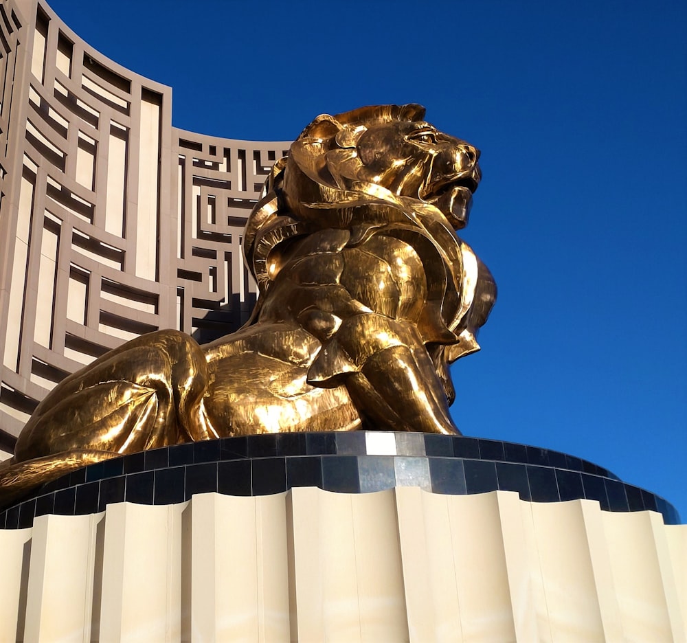 a golden lion statue sitting on top of a building